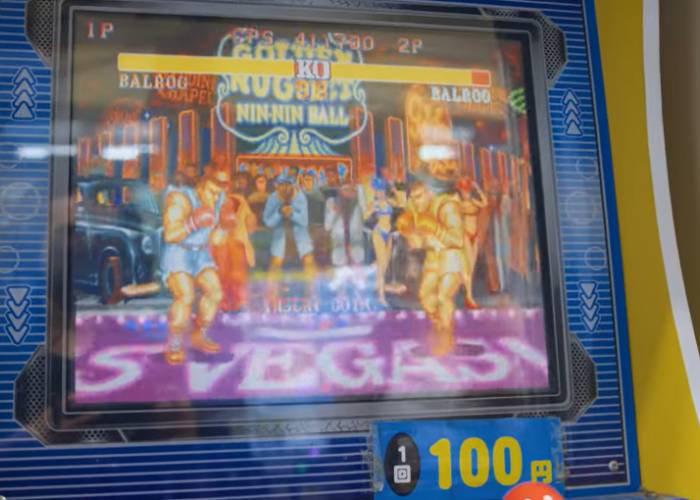 A retro Street Fighter arcade machine, showing two characters ready to fight.